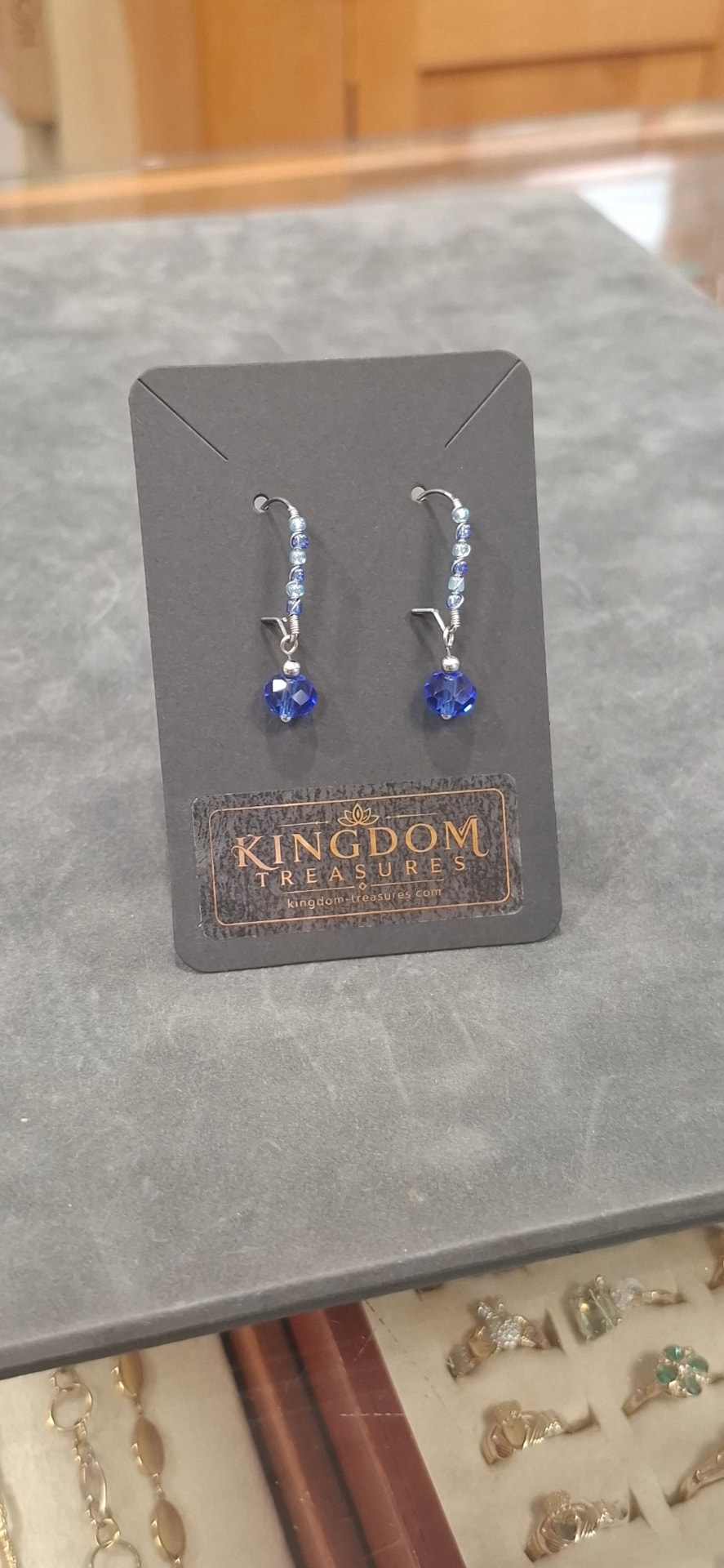 Blue crystal drop earrings on Kingdom Treasures packaging